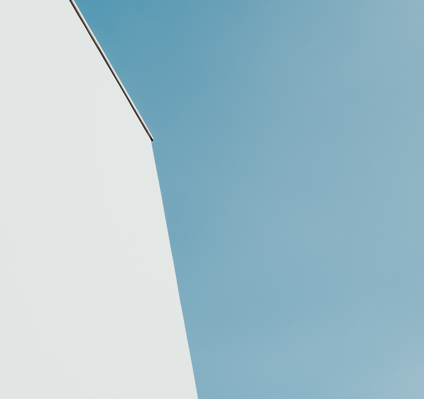 A abstract photo of a building with turquoise sky