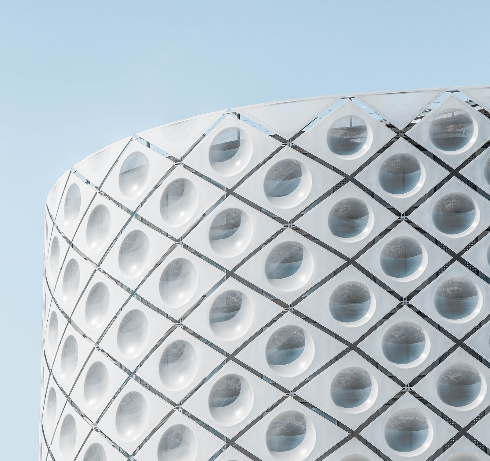A building with circular windows and a blue sky